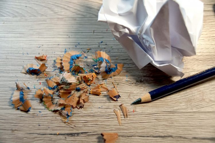 Spitzerreste vom Buntstift und zerknülltes Papier