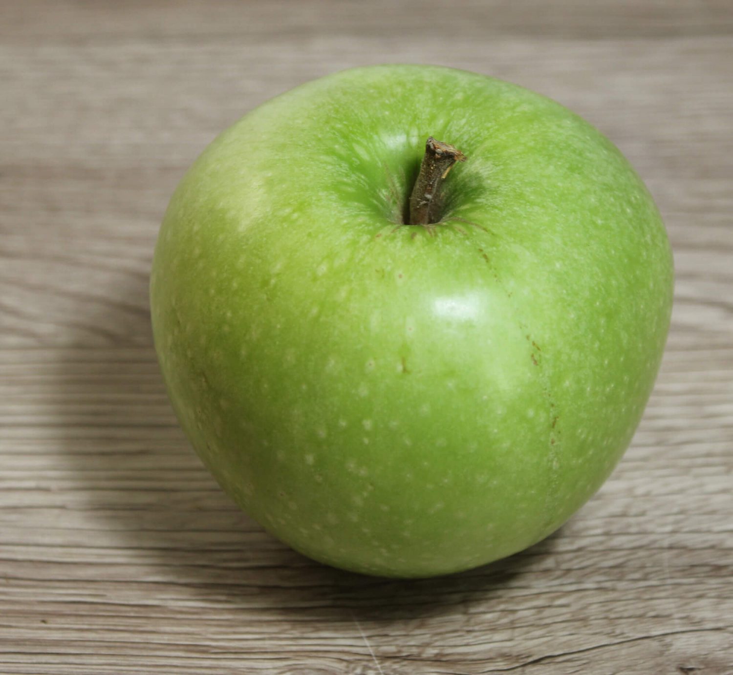 Fotovorlage: Grüner Apfel in Aufsicht